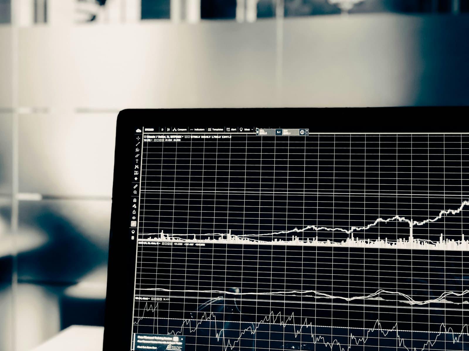 A monitor displaying dense time-series charts and gridlines in near-monochrome.